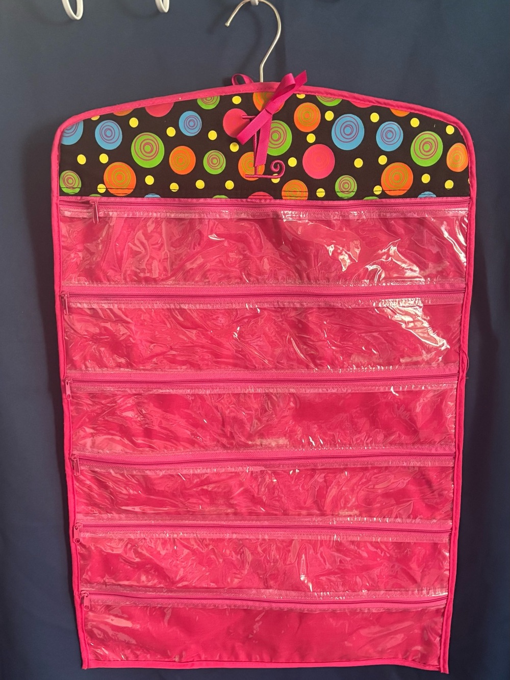 Bright Pink Hanging Jewelry Organizer with Clear Zip Pockets both sides.